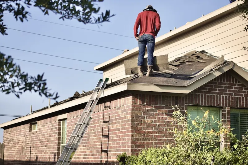 Professional roofer working on a residential roof in Discovery Village